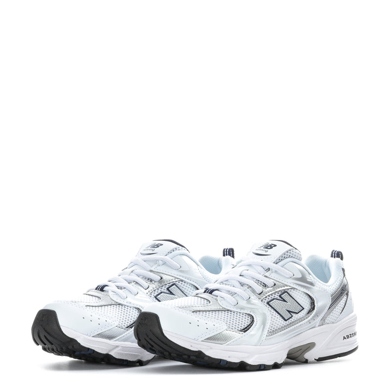 Pair of kids white running sneakers with navy accents and N logo on front