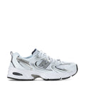 White youth sneaker with navy accents, lace-up front and N logo side