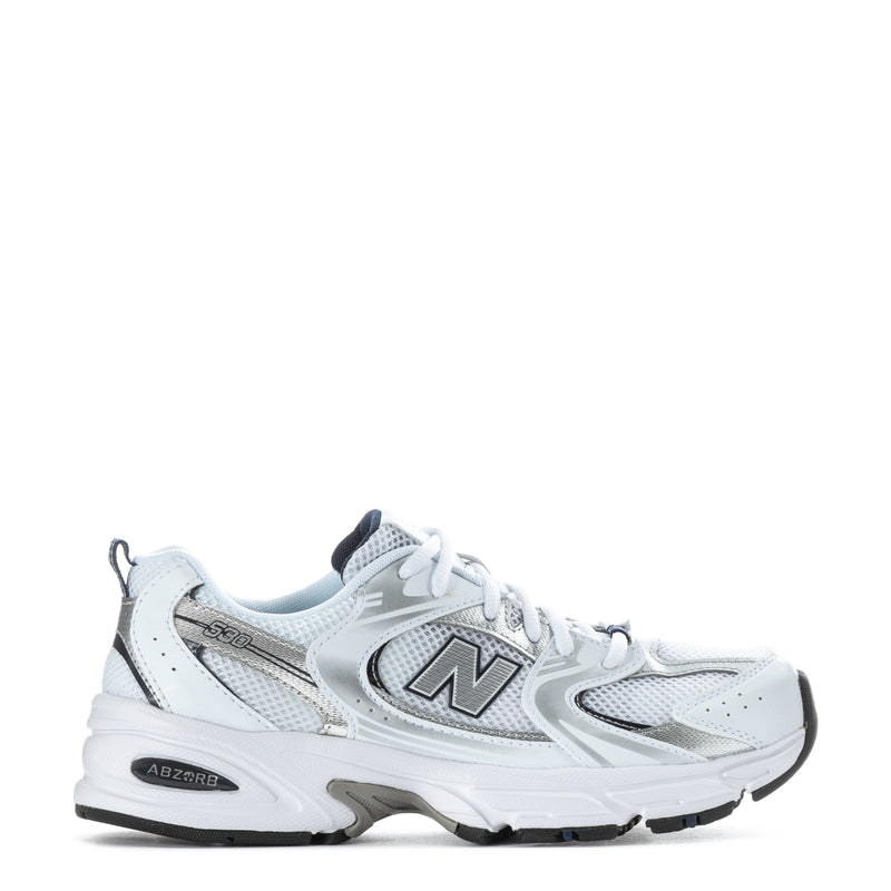 White youth sneaker with navy accents, lace-up front and N logo side
