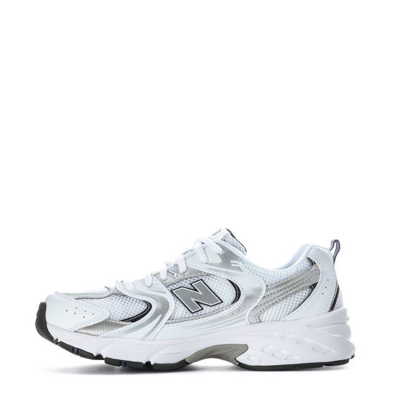 White youth sneaker side view with mesh panels, N logo, and black tread sole