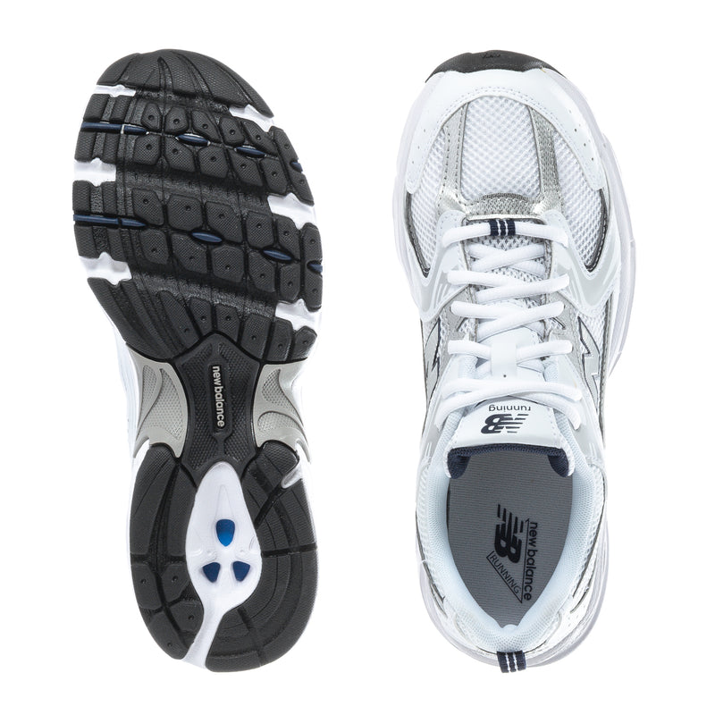 Youth sneaker with white upper and dark rubber outsole, showing heel and tread