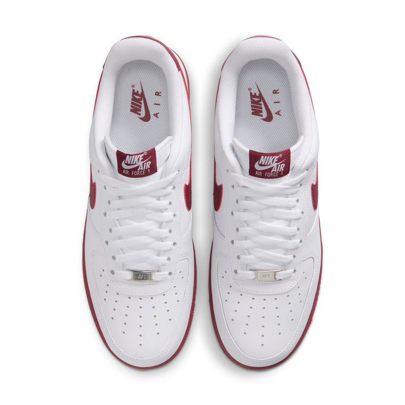 Men's white Nike Air Force 1 sneakers, top view of laces and perforated toe