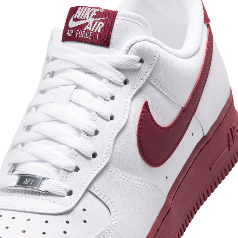 Close-up of men's Nike Air Force 1 low-top: white laces and Team Red Swoosh panel