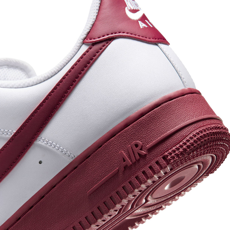 Close-up of men's Nike Air Force 1 midsole and quarter panel in white and Team Red