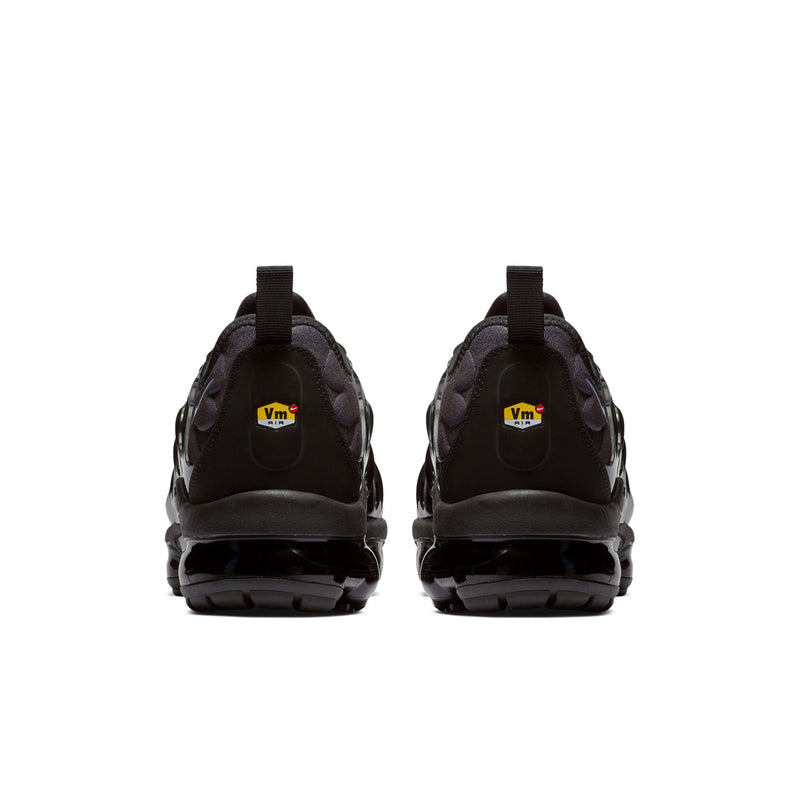 Back view of sneakers with black heel panels, Vm logo tab, and Air sole