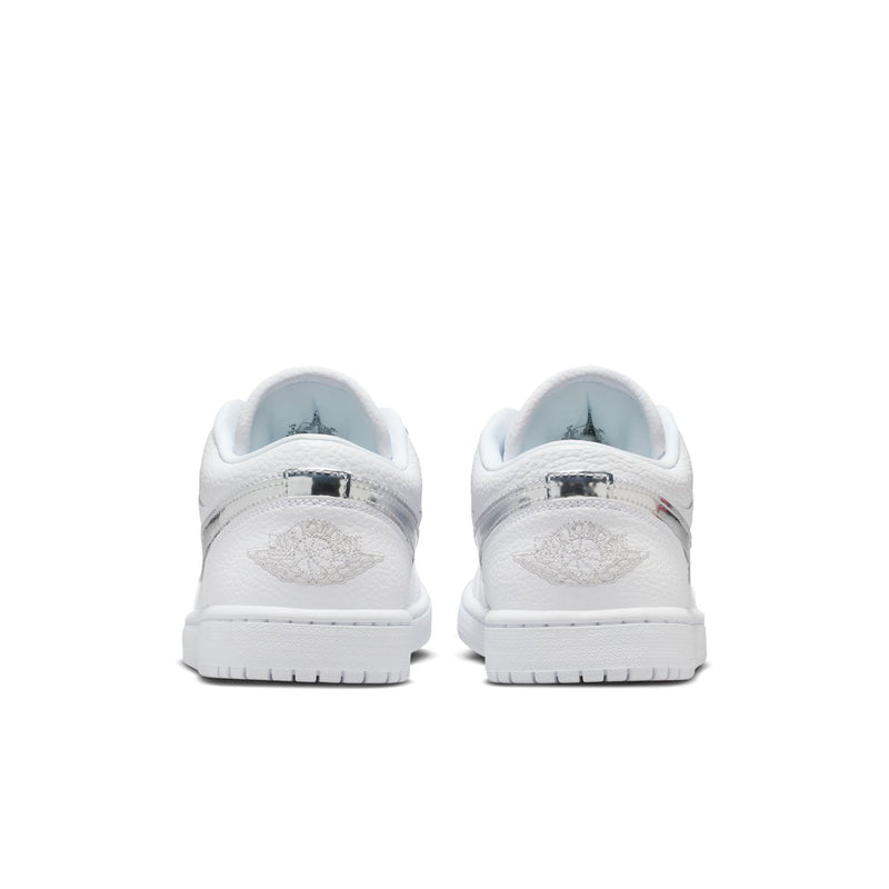 Pair of women's white low-top sneakers, rear view with back tabs and rubber soles