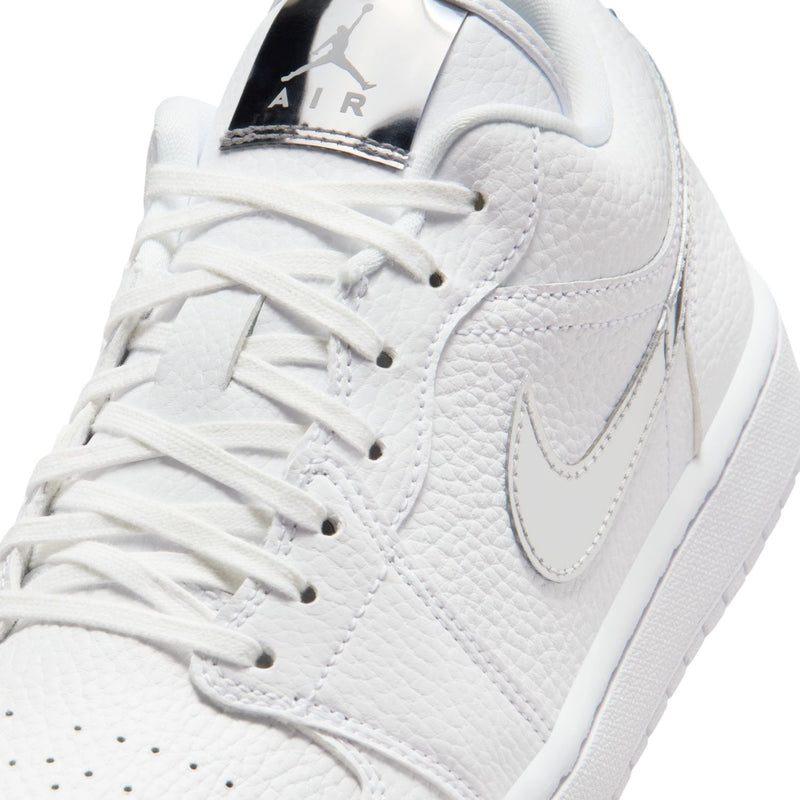 Women's white sneaker close-up with laces, pebble-texture leather, and Nike Air tongue logo