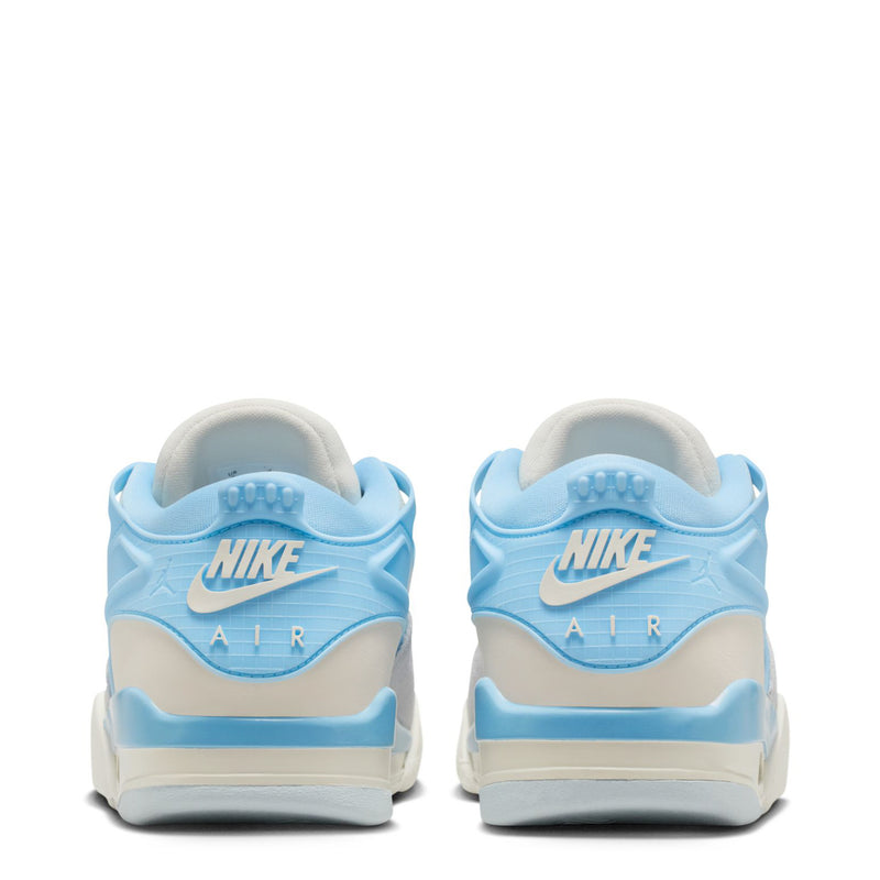 Women's heel view sneaker in light blue and pale ivory with 'AIR' logo.