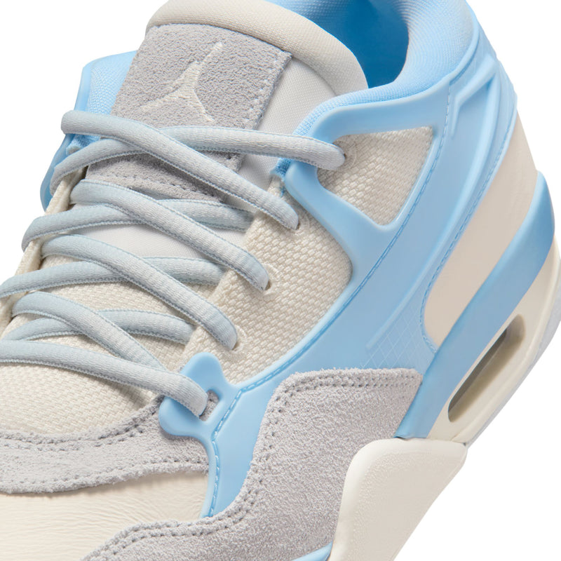 Women's sneaker upper close-up with light blue side panel and lace stitching.