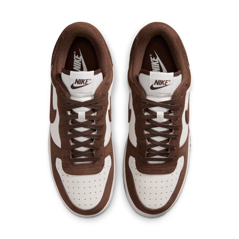 Men's low-top Nike sneakers showing white interior lining and brown lace-up vamp