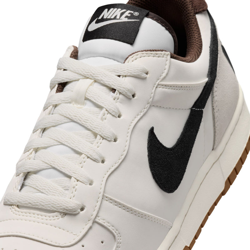 Close-up of men's Nike low-top sneaker lace-up front with black swoosh