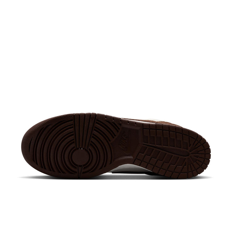 Brown rubber outsole view of men's low-top Nike sneakers with textured traction tread