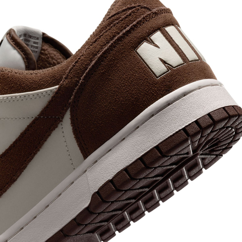 Close-up heel and outsole of men's low-top Nike sneakers with NIKE logo and tread pattern