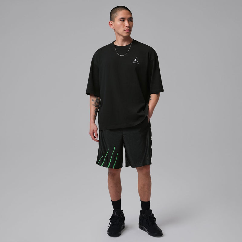 Men's black shorts with green stripe detail, elastic waistband and logo