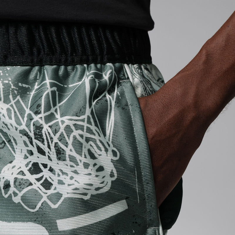 Dark green graphic shorts with white web print, visible drawcord detail