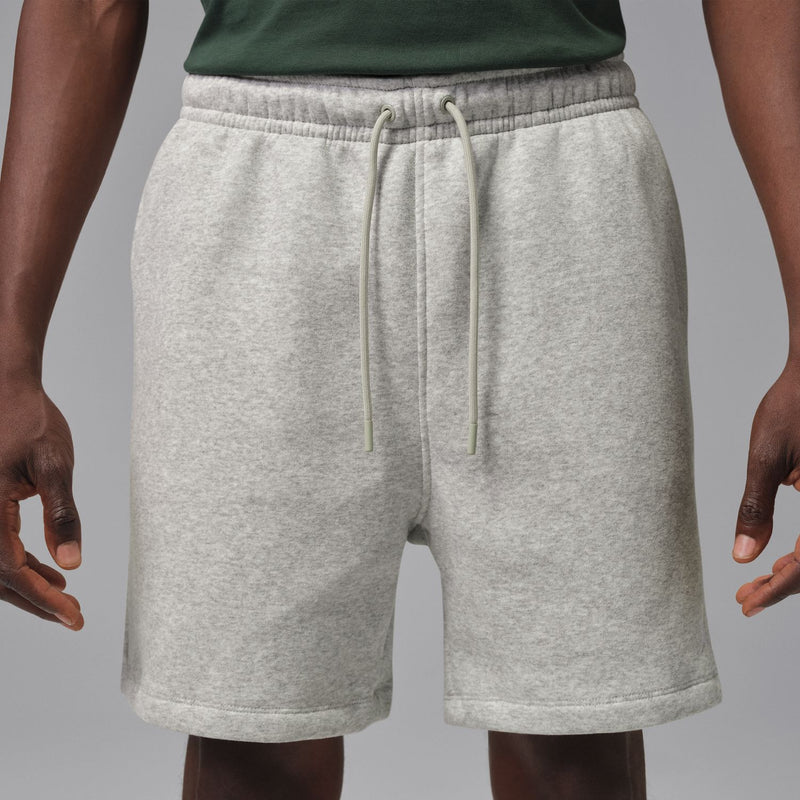 Heather grey men's fleece shorts on model, drawstring and elastic waist
