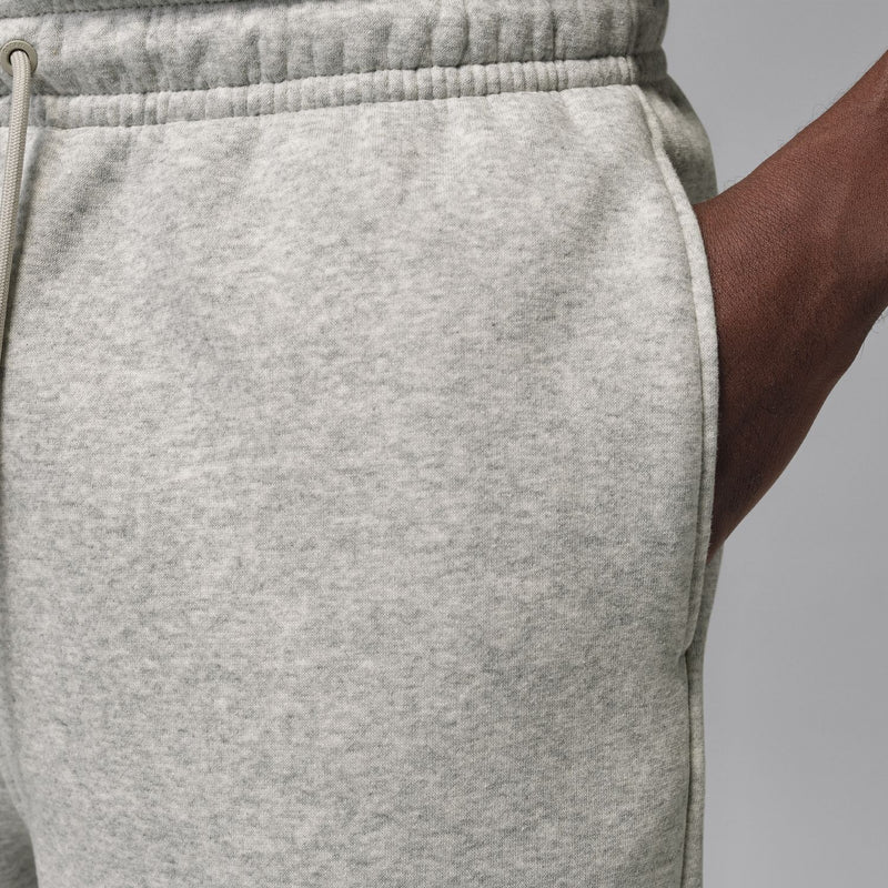 Close-up of heather grey fleece shorts waistband and elastic drawcord