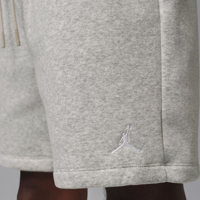 Close-up of heather grey fleece shorts hem with Jumpman logo