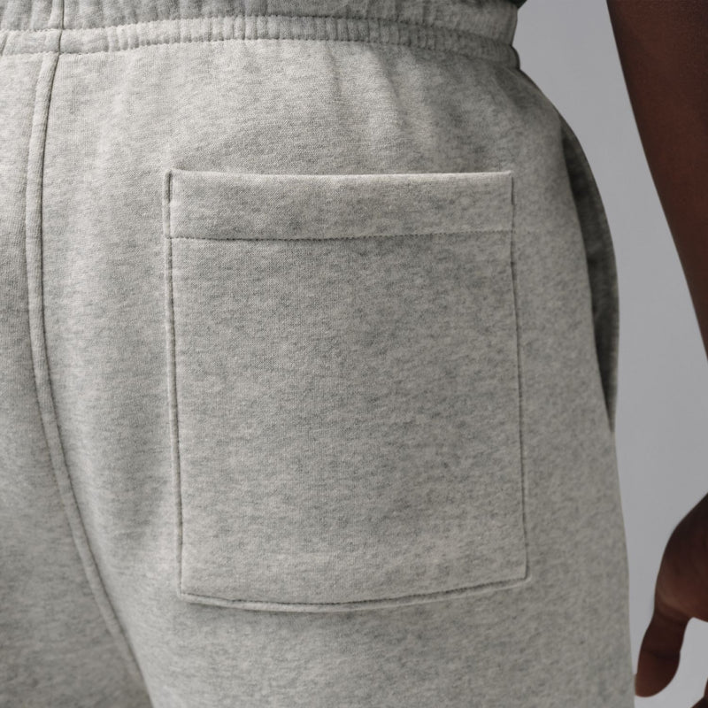 Close-up of heather grey fleece shorts back pocket with stitch lines
