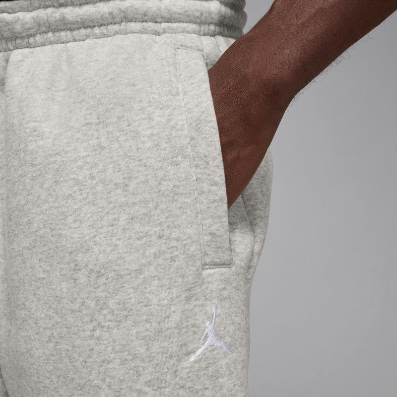 Heather grey sweatpants close-up: elastic waistband and side pocket seams