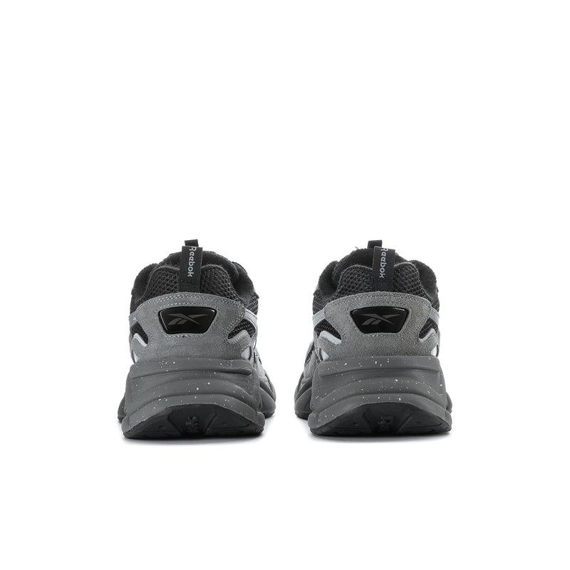 Men's grey and black running sneakers, rear view with heel tabs