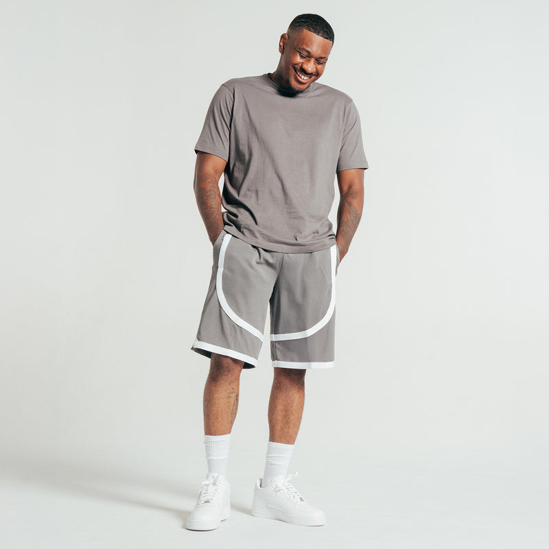 Castlerock gray crew T-shirt with short sleeves, knotted hem, worn with shorts.