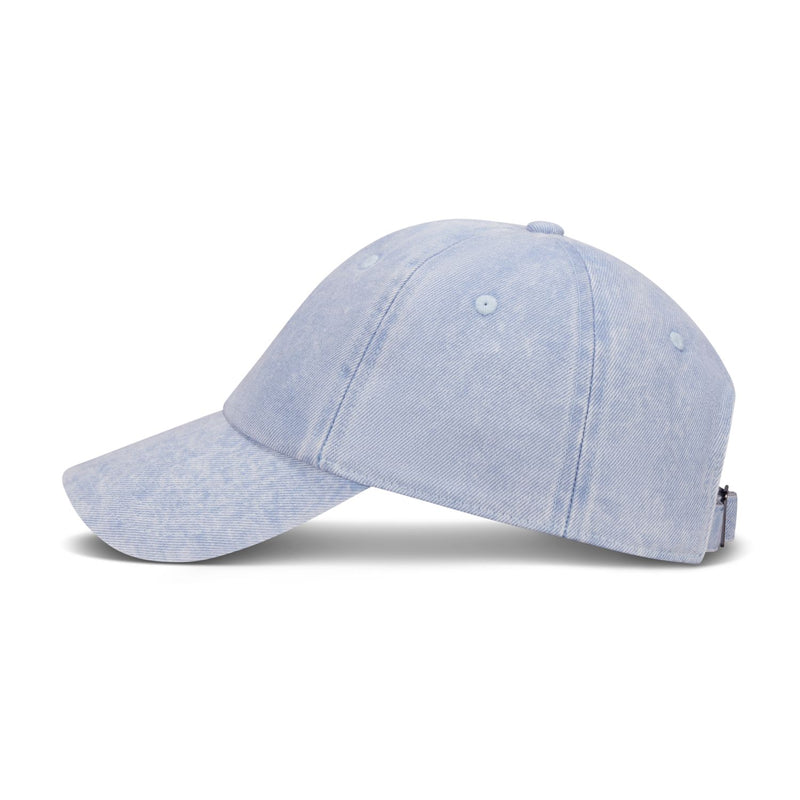 Light blue denim Nike unstructured cap on its side with curved bill and strap