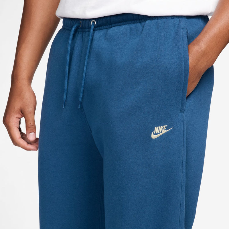 Men's court blue fleece pants with drawstring waist and Nike logo on the thigh