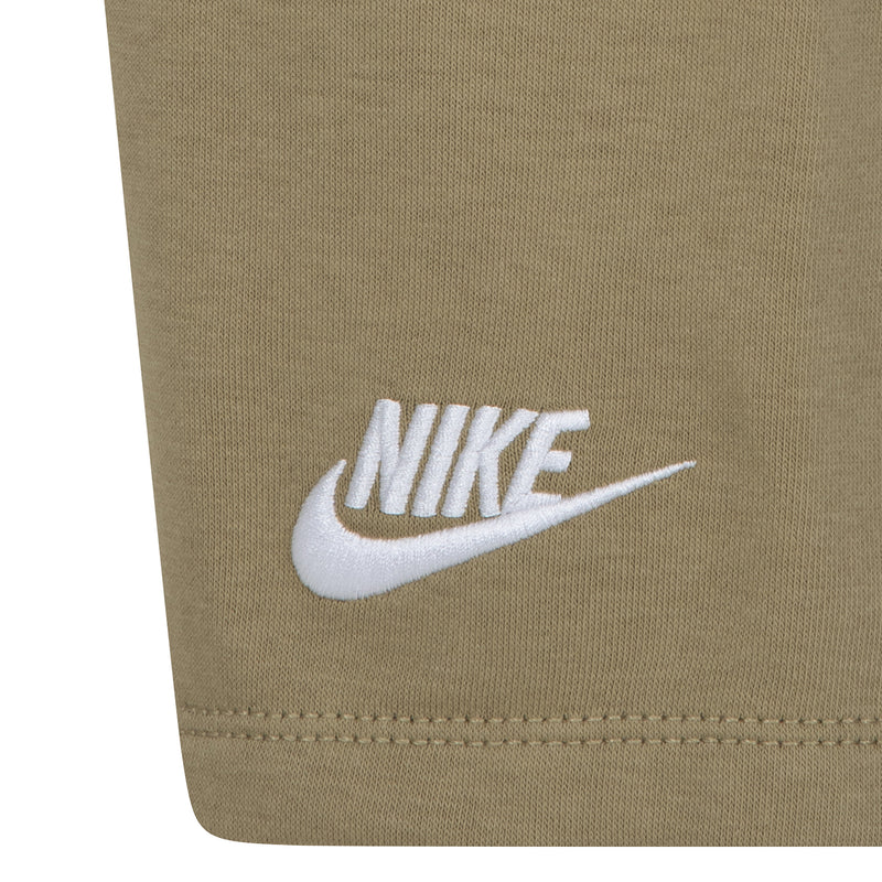 Beige kids shorts with white NIKE swoosh logo near the hem