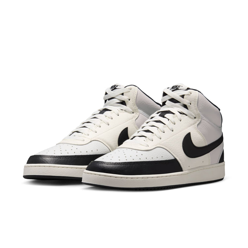 Men's mid-top sneakers, off-white uppers with black swoosh on both shoes.