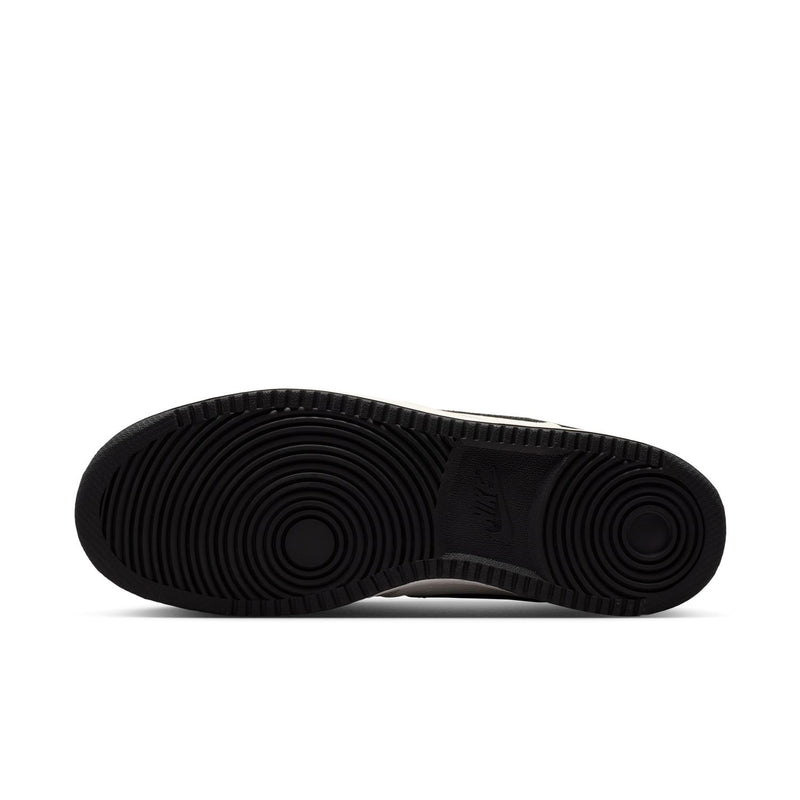 Men's sneaker outsole with black herringbone traction pattern.