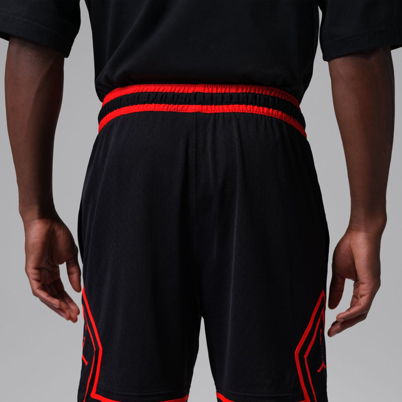 Men's black athletic shorts with red side piping and elastic waistband