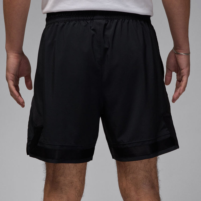 Men's black woven shorts, back view with elastic waistband and relaxed drape
