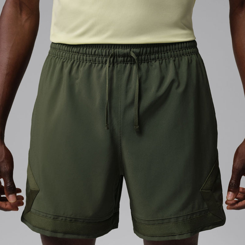Men's olive woven cargo shorts with elastic waistband, drawstring, and angled side pockets