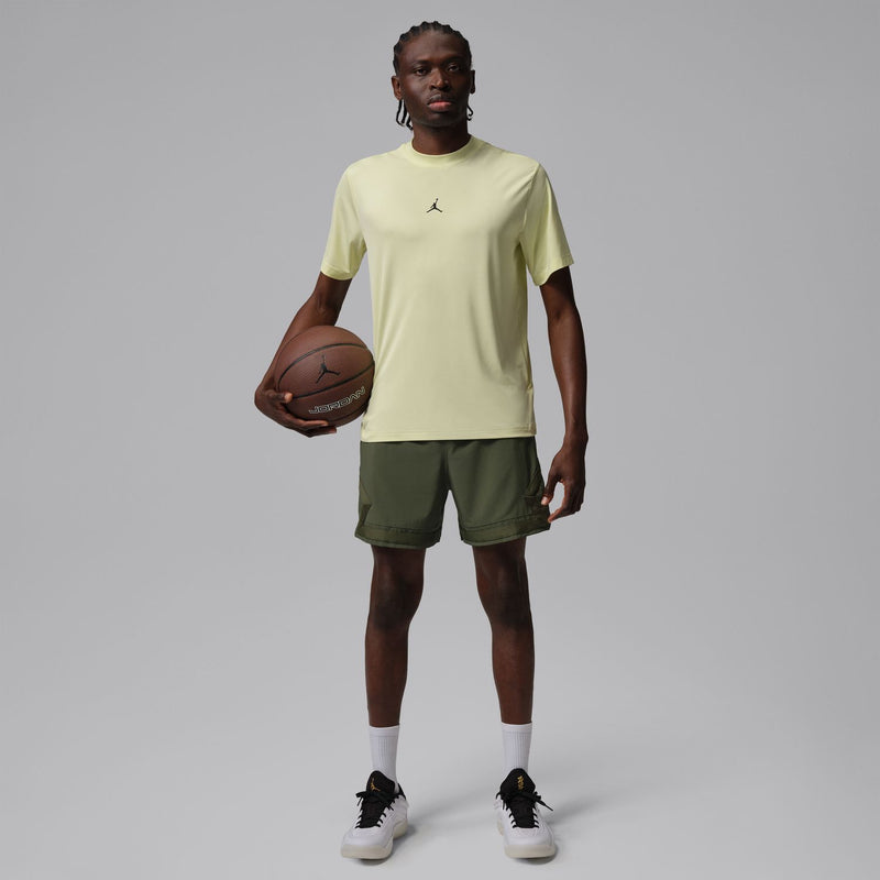 Men's olive woven cargo shorts worn with sneakers, elastic waist and side pocket seams