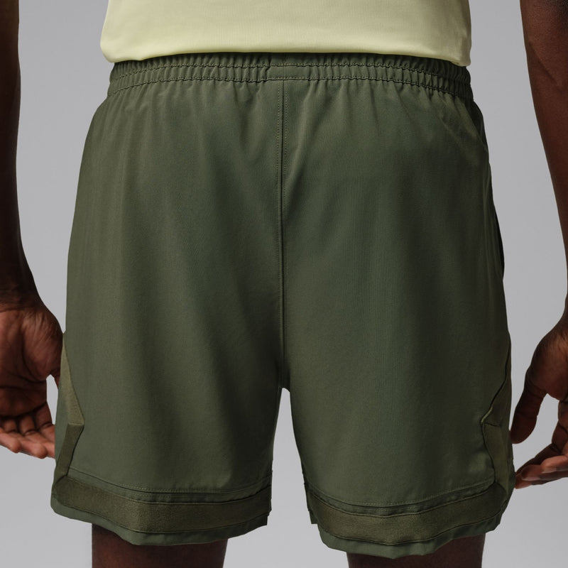 Men's olive woven cargo shorts with elastic back waistband and side pocket openings