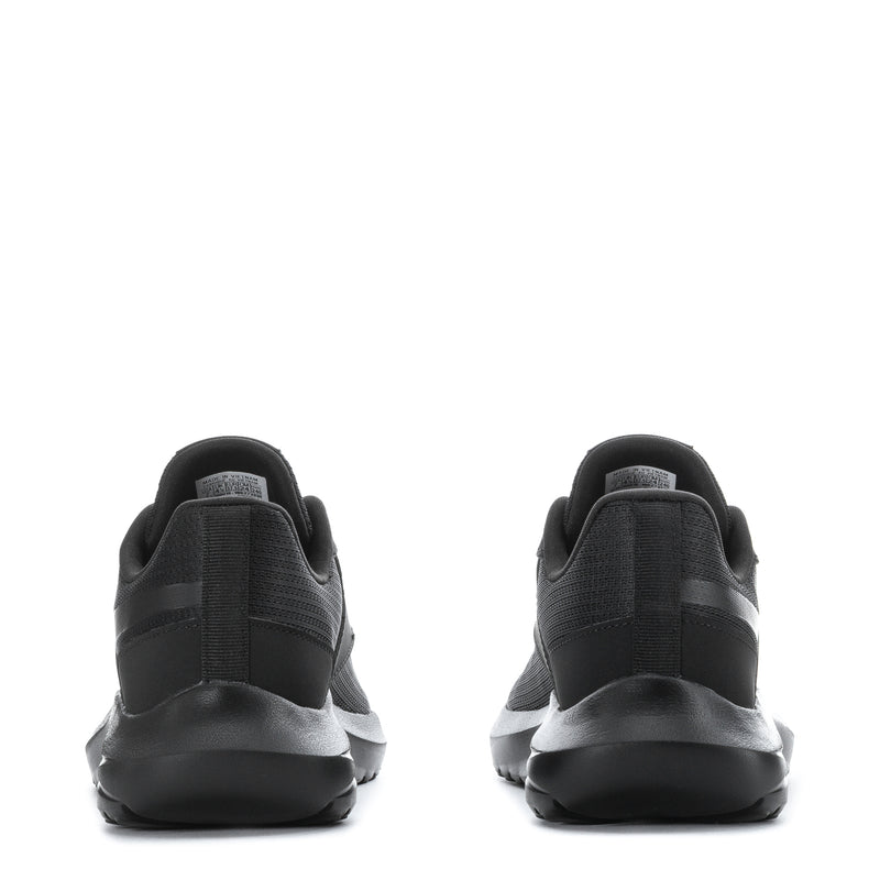 Women’s black sneakers, rear view with pull tab and cushioned sole