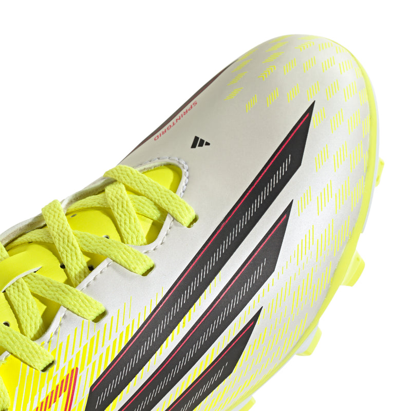 Youth soccer cleat upper close-up with neon yellow laces, gray base, black and red stripes