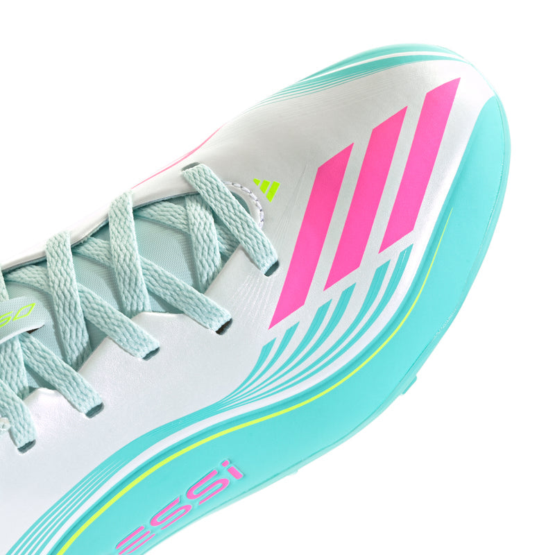 Kids soccer cleat close-up, white upper with aqua sidewall and pink stripe design