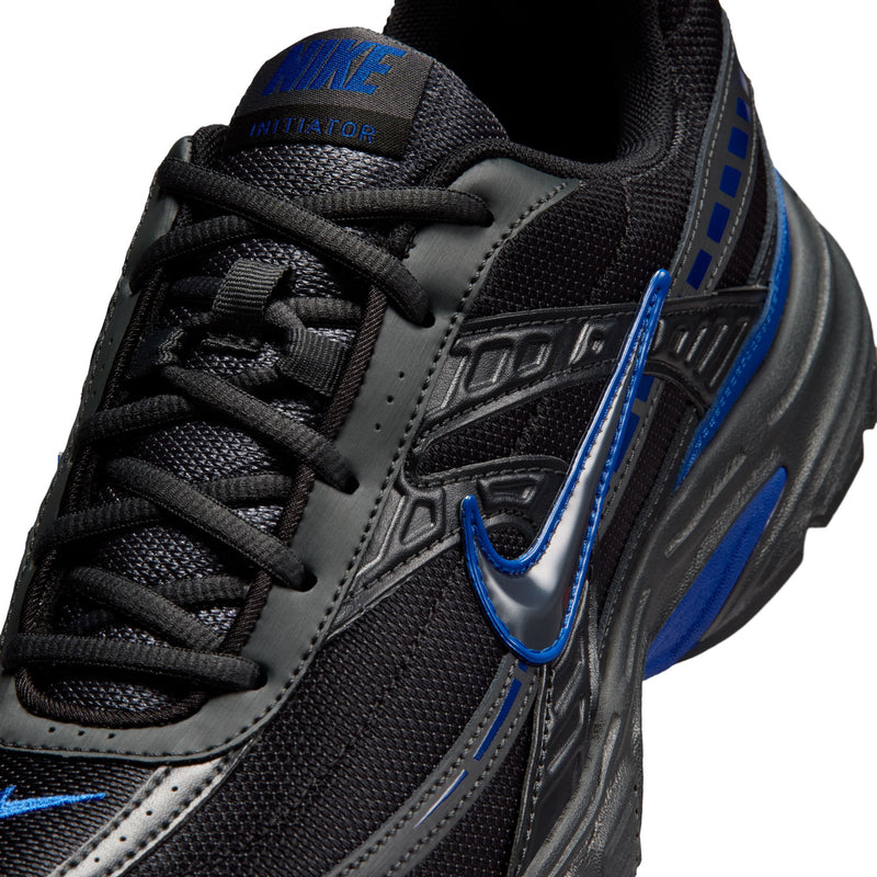 Men's black running shoe close-up, blue swoosh, laces, textured mesh upper