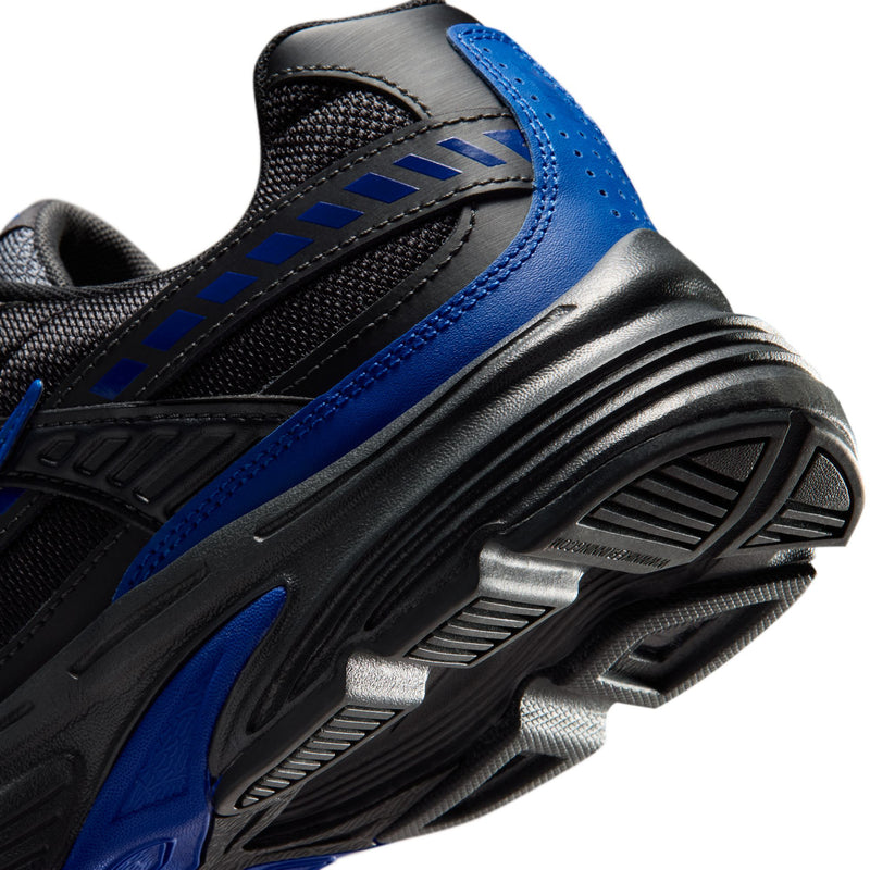 Men's black and blue outsole close-up, ribbed grooves and traction tread blocks