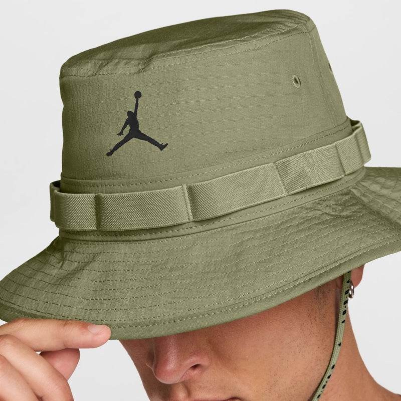 Olive green bucket hat close-up with black Jumpman emblem and banded brim