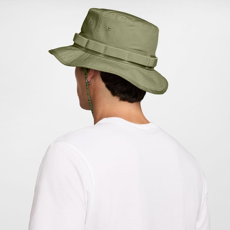 Olive green bucket hat viewed from side/back with chin cord and ventilation eyelets