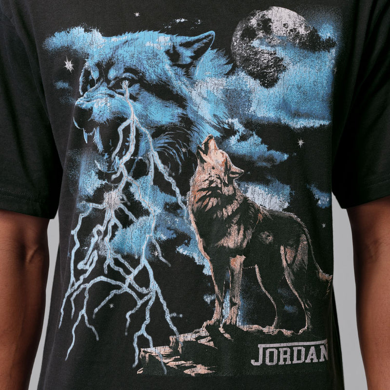Dark T-shirt close-up: blue wolf and moon screen print with stars