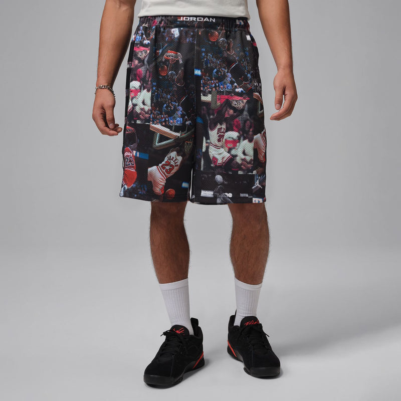 Black mesh basketball print shorts worn by model with crew socks and sneakers