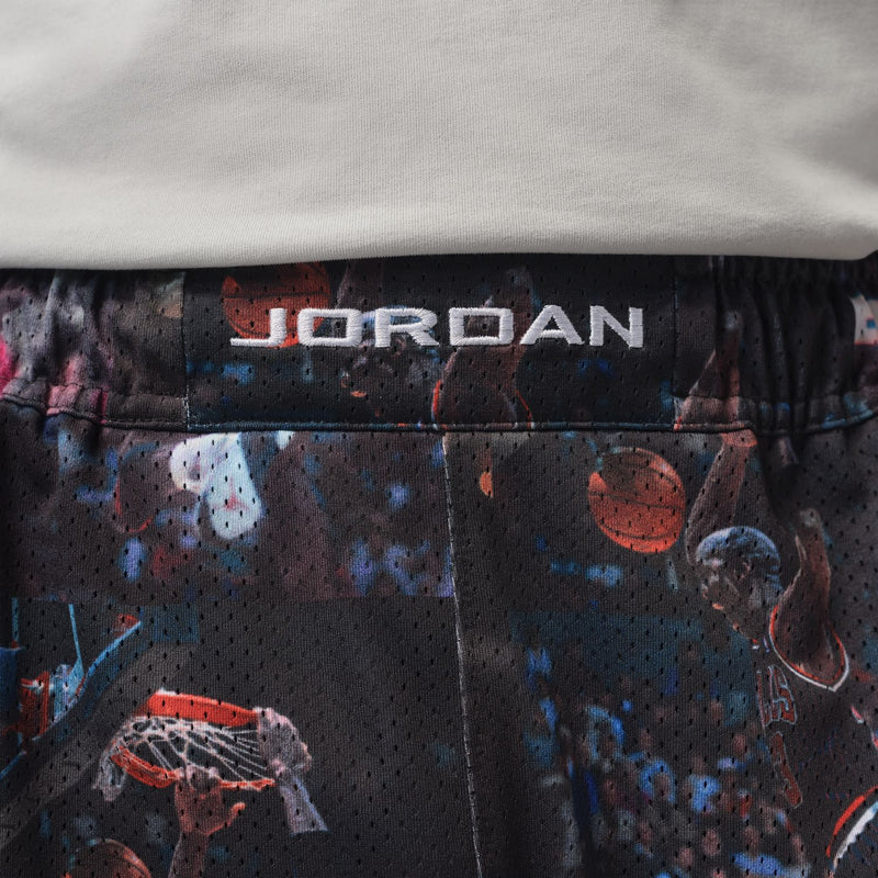 Black mesh waistband with JORDAN logo over colorful basketball print shorts