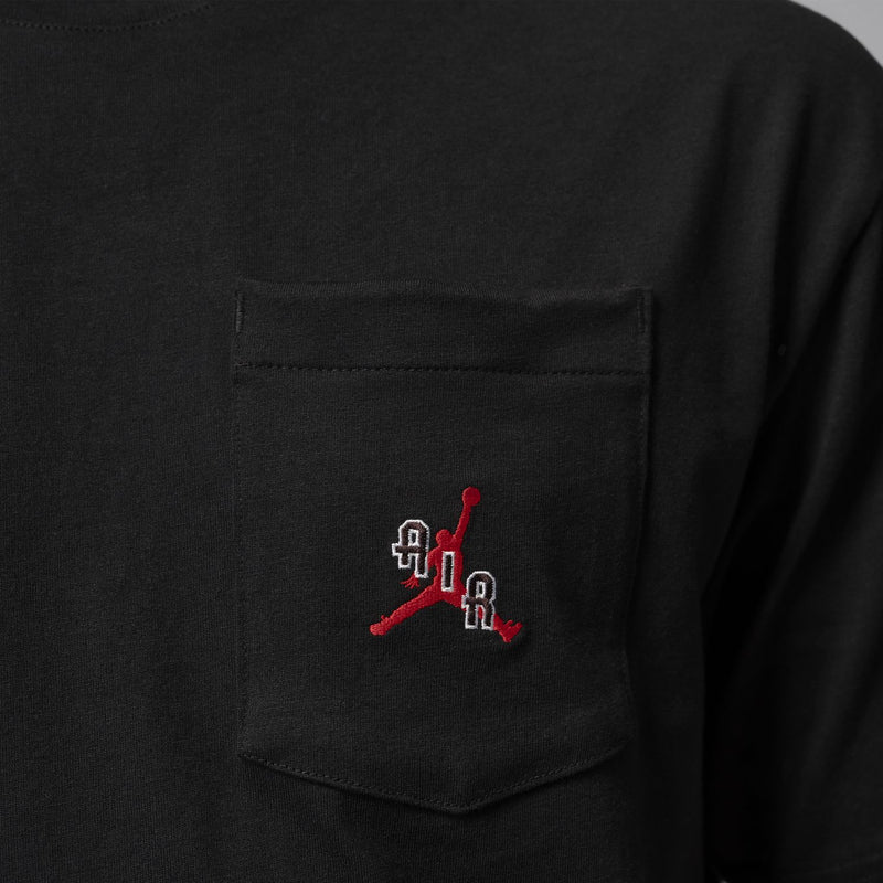 Black chest pocket on crewneck T-shirt with small red and white logo