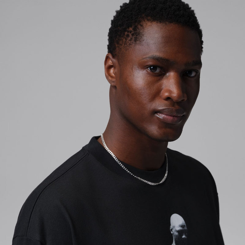 Black crewneck T-shirt with white athlete graphic print and red Jumpman detail