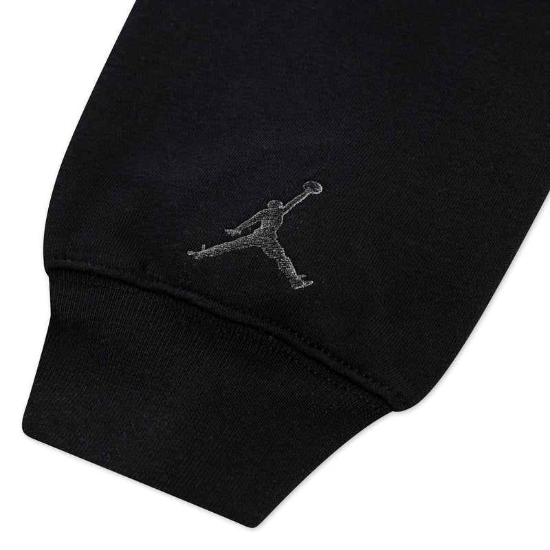 Youth black fleece hoodie sleeve cuff with Jumpman logo, close-up