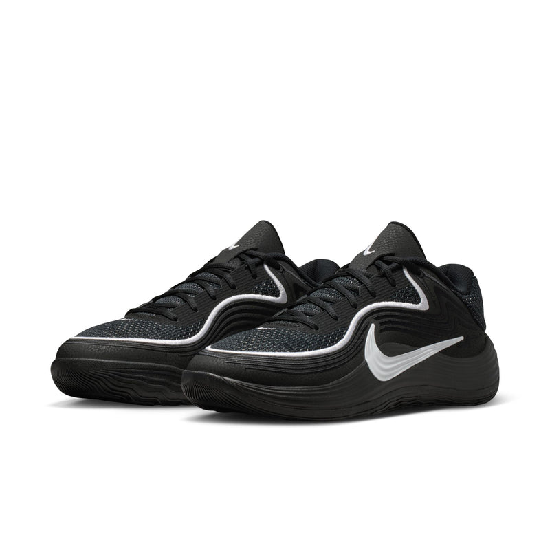 Men's black low-top sneakers, side view with white swoosh and textured sole